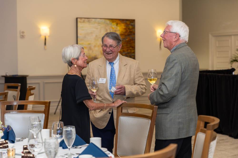 Happy Fox smiling in conversation with two other guests